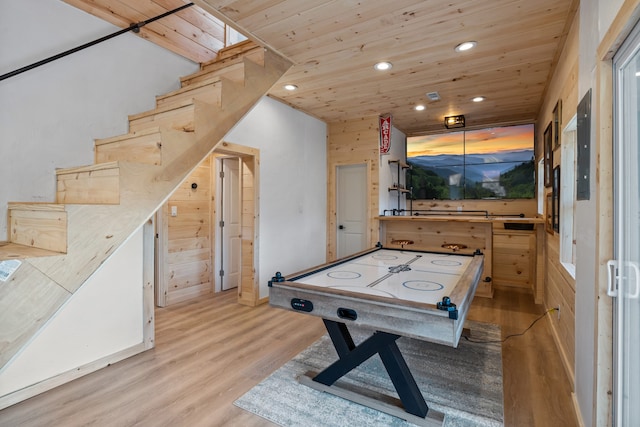 playroom featuring wooden ceiling, wood walls, and light hardwood / wood-style flooring