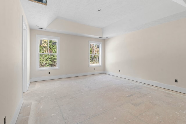 empty room with plenty of natural light and a textured ceiling