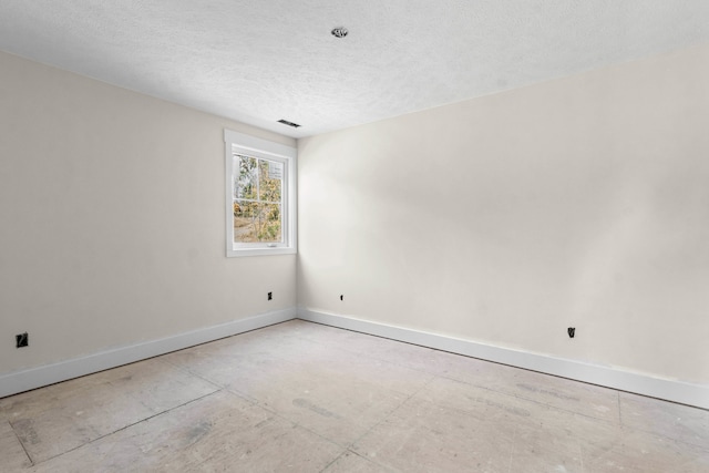 spare room featuring a textured ceiling