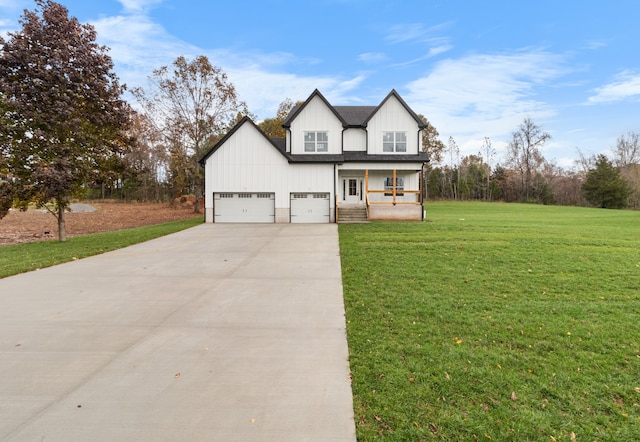 view of front of property with a garage and a front lawn