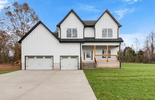 view of front facade with a garage, a porch, and a front lawn