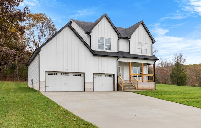 view of front of house featuring a garage, a front yard, and covered porch