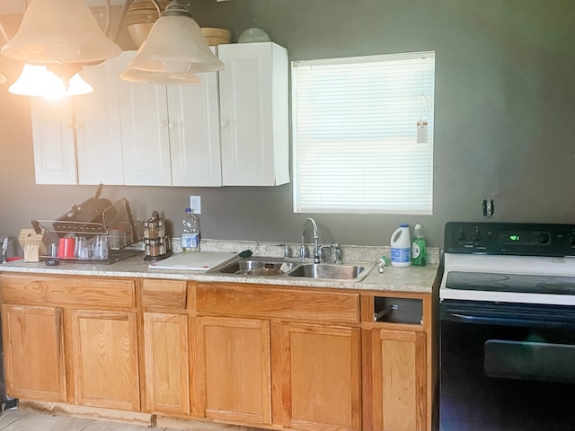 kitchen featuring sink, white range, and decorative light fixtures