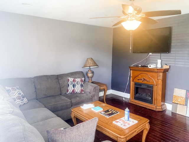 living room with dark hardwood / wood-style flooring and ceiling fan