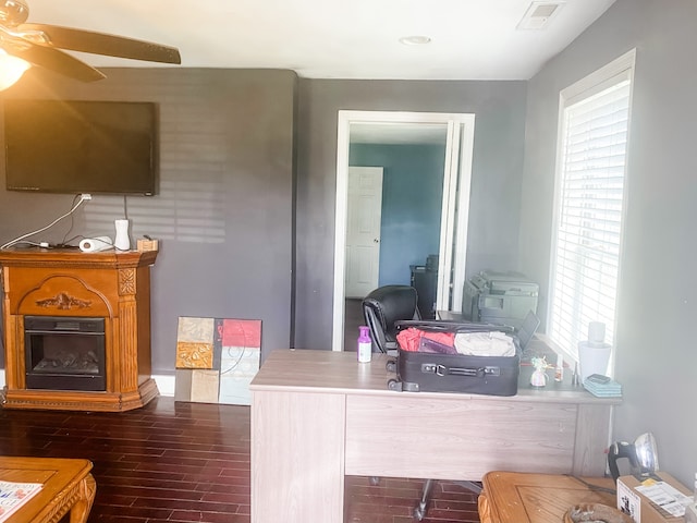 home office featuring dark hardwood / wood-style floors and ceiling fan