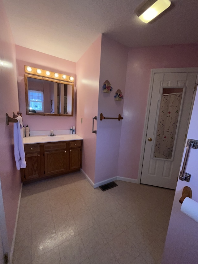 bathroom featuring tile flooring and vanity