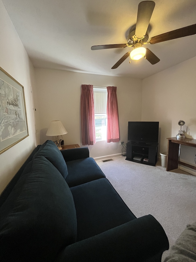 carpeted living room with ceiling fan