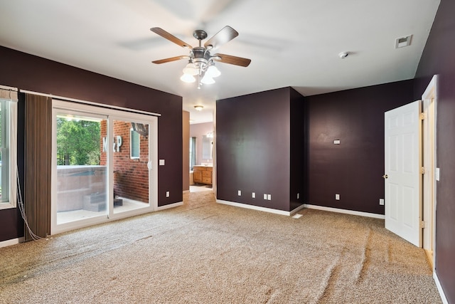 unfurnished room featuring light colored carpet and ceiling fan