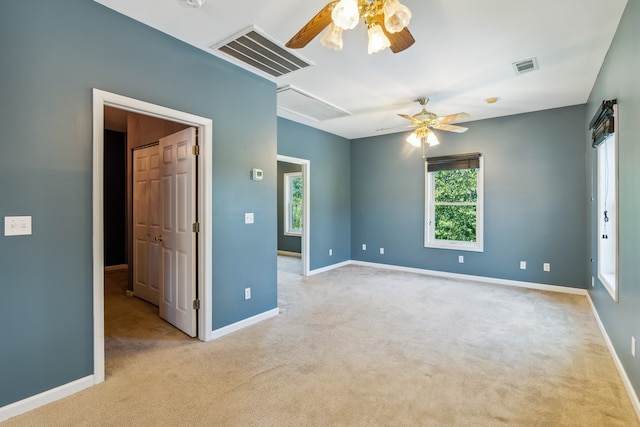 unfurnished room with light carpet and ceiling fan