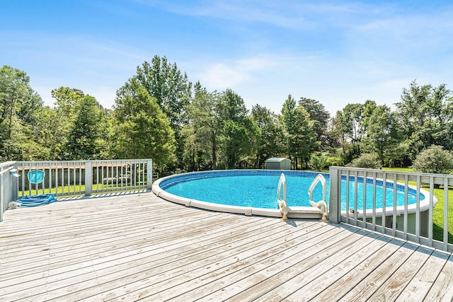 view of swimming pool with a wooden deck