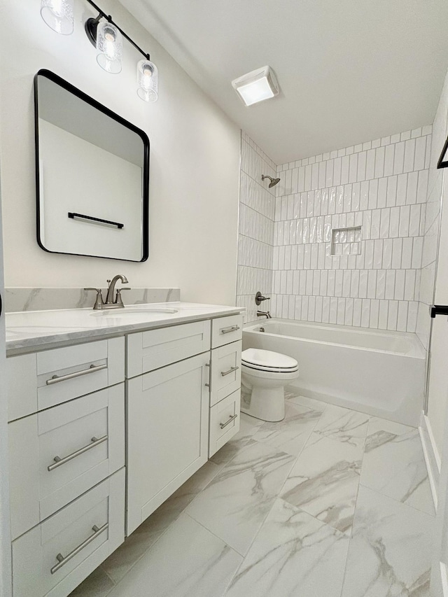 bathroom featuring toilet, marble finish floor, shower / washtub combination, and vanity