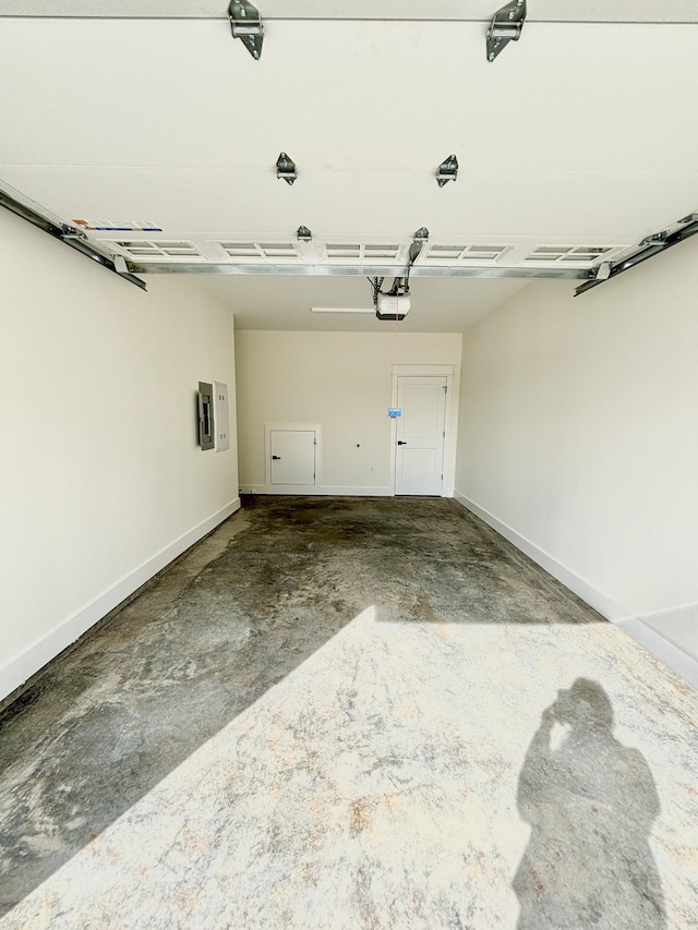 garage with baseboards and a garage door opener