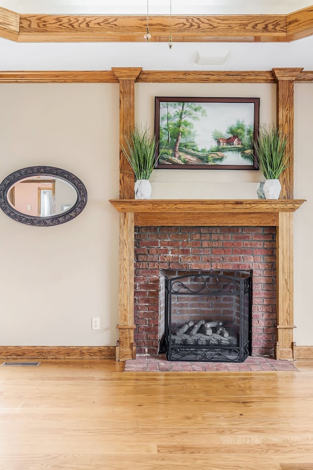 interior details with hardwood / wood-style flooring and a brick fireplace