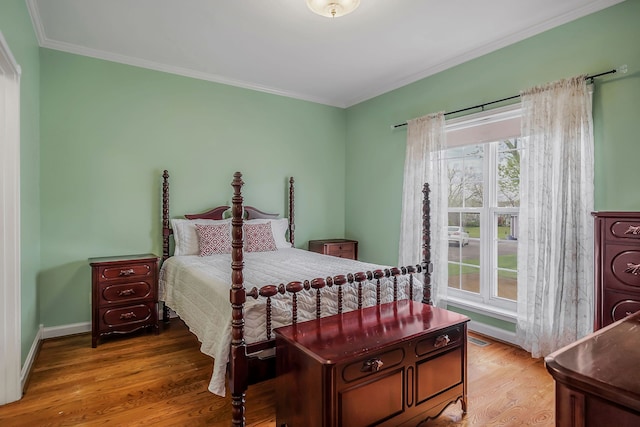 bedroom featuring wood-type flooring and crown molding