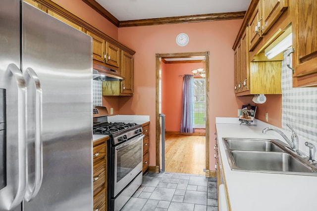 kitchen with ornamental molding, sink, light tile flooring, and stainless steel appliances