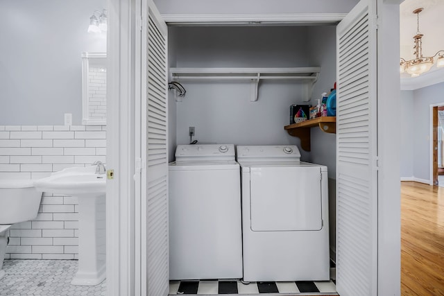 washroom with independent washer and dryer and light tile floors