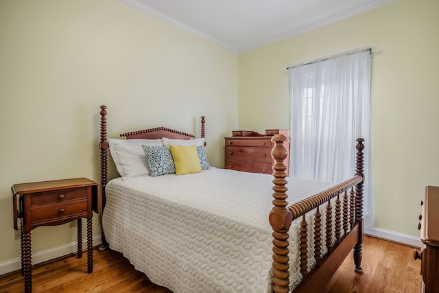 bedroom featuring crown molding and light wood-type flooring