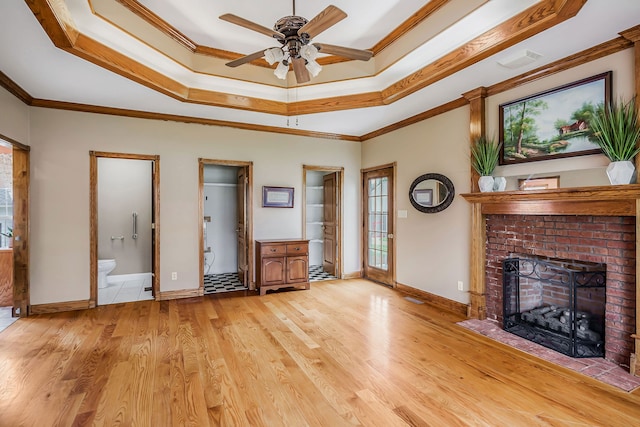 interior space featuring a brick fireplace, ceiling fan, light tile floors, and ornamental molding