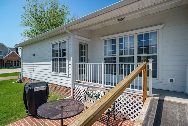 wooden terrace featuring a lawn