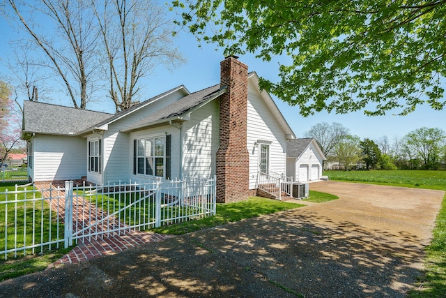 view of property exterior featuring central AC and a yard