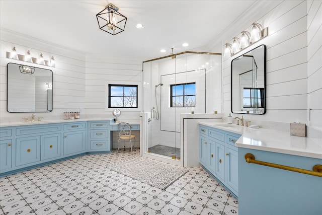 bathroom with wood walls, tile floors, crown molding, a shower with door, and vanity