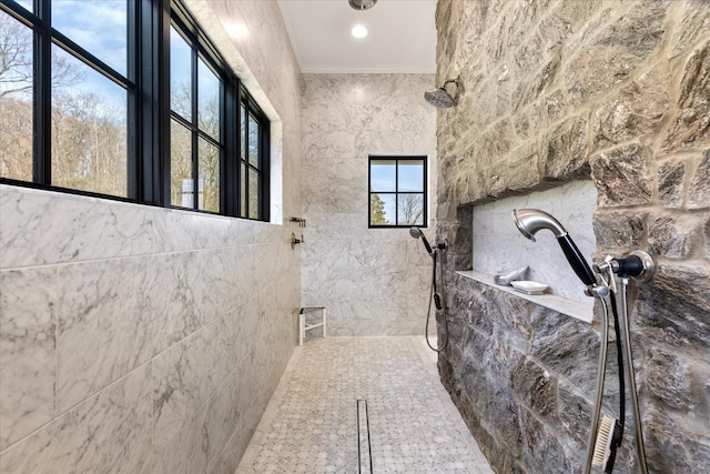 bathroom featuring tile flooring, walk in shower, tile walls, and crown molding