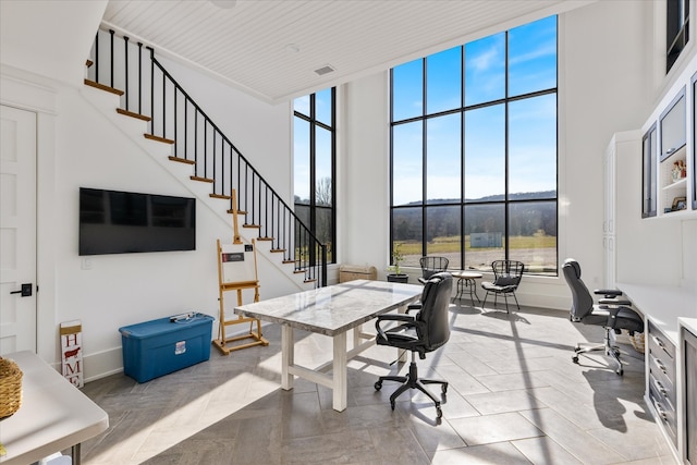 office with a high ceiling, plenty of natural light, and a mountain view