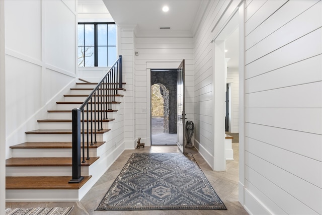 foyer featuring ornamental molding