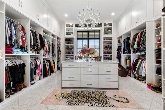 walk in closet featuring a notable chandelier and light tile floors