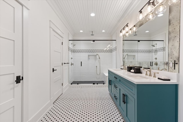 bathroom featuring double sink, walk in shower, ornamental molding, and large vanity