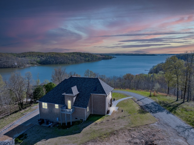 aerial view at dusk with a water view