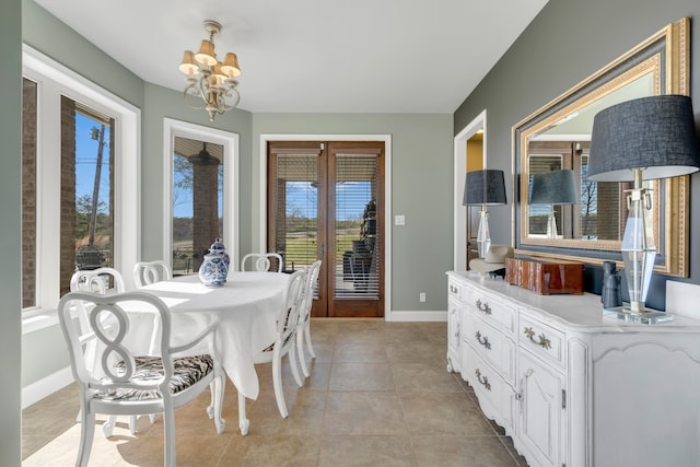 tiled dining space featuring a notable chandelier