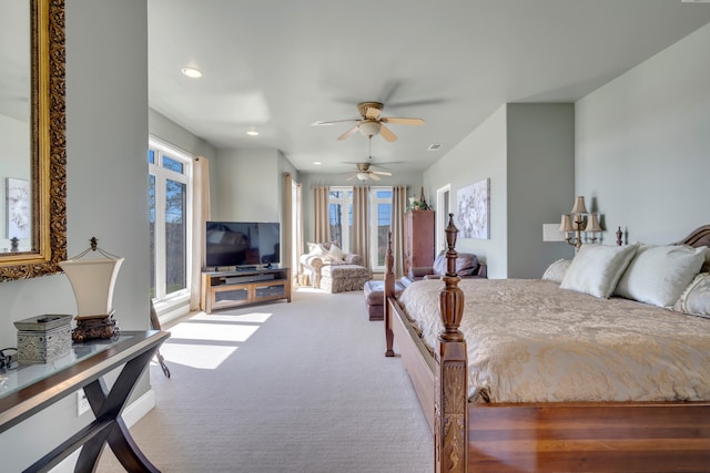 bedroom with ceiling fan and light carpet