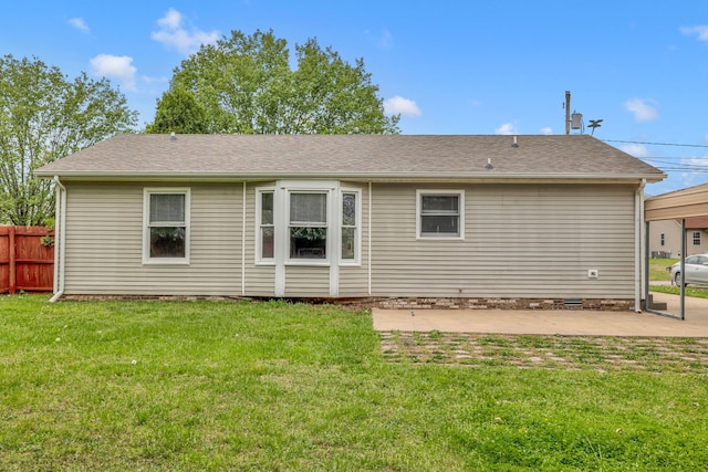 back of property with a patio area and a yard