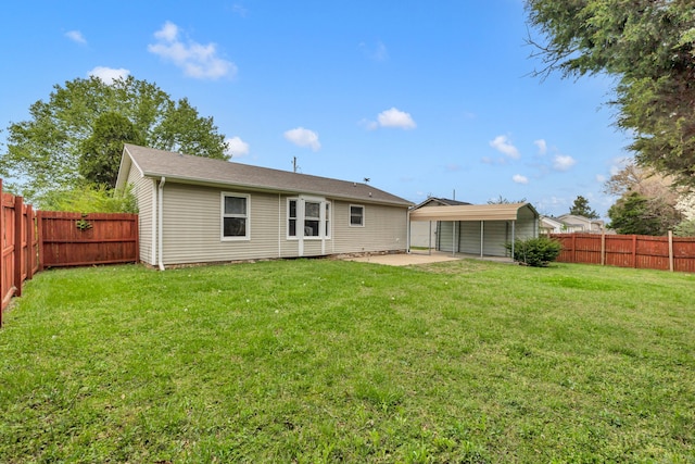 rear view of house with a lawn and a patio