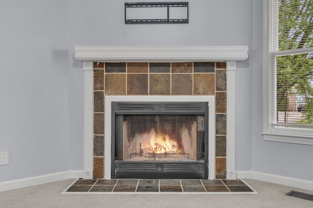 room details featuring carpet flooring and a tile fireplace