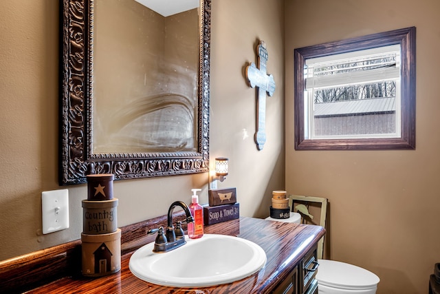 bathroom featuring toilet and vanity