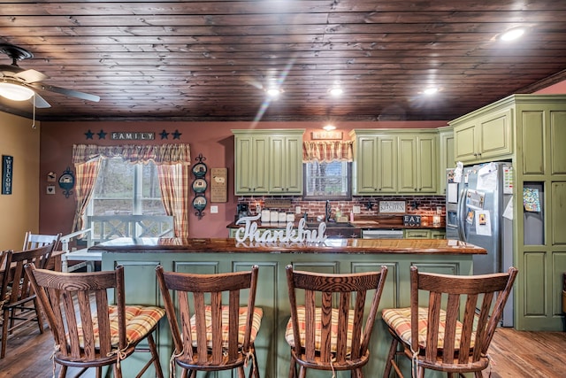 kitchen with wood-type flooring, ceiling fan, a wealth of natural light, and green cabinets