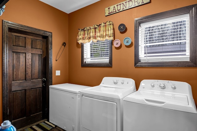 clothes washing area featuring washer and clothes dryer