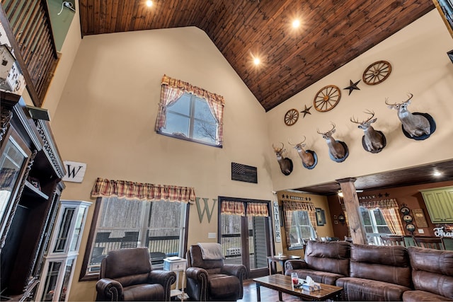 living room featuring high vaulted ceiling, ornate columns, wood ceiling, and wood-type flooring