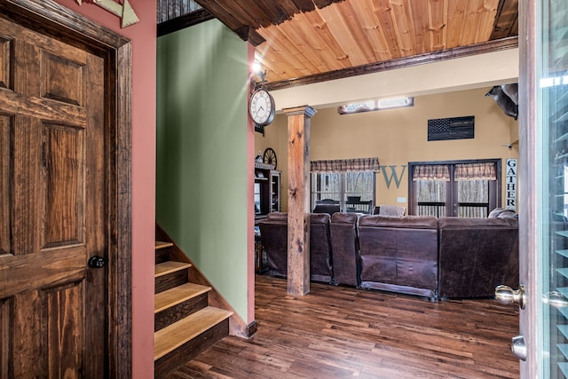 foyer entrance featuring dark wood-type flooring and wooden ceiling