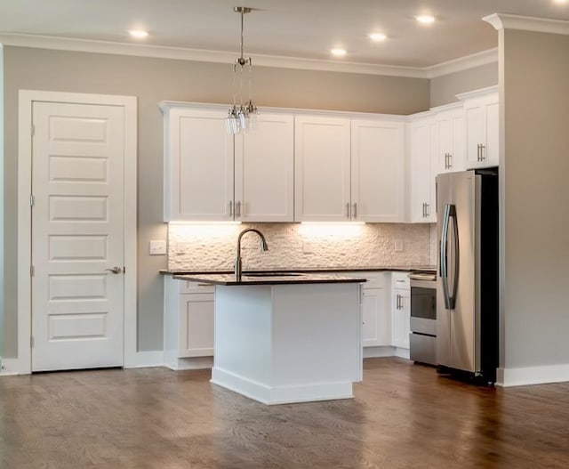 kitchen with stainless steel refrigerator, dark wood-type flooring, stove, white cabinetry, and backsplash