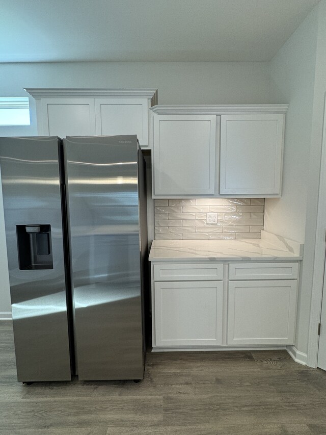 kitchen featuring decorative backsplash, stainless steel refrigerator with ice dispenser, wood finished floors, and white cabinets