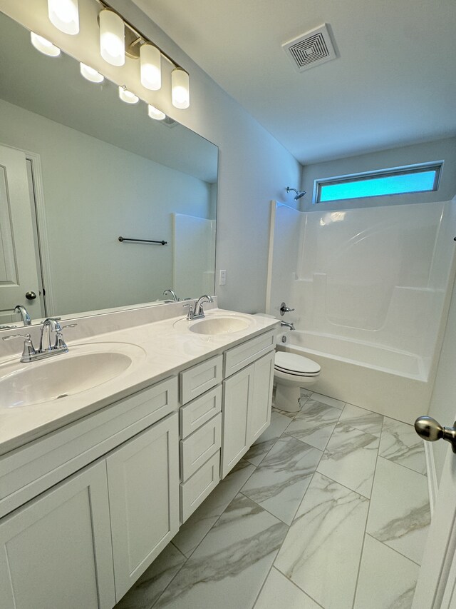 bathroom featuring marble finish floor, bathtub / shower combination, visible vents, and a sink