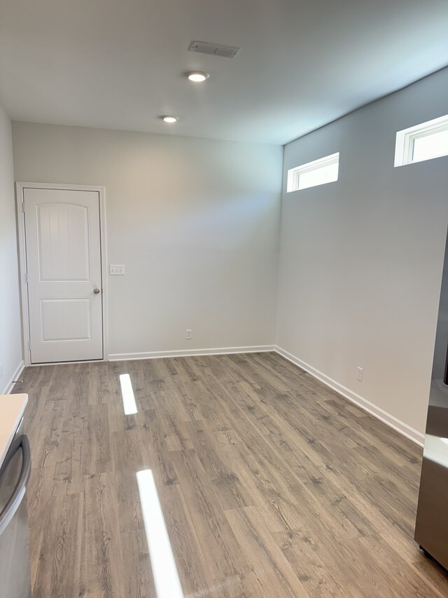 below grade area featuring visible vents, baseboards, and wood finished floors