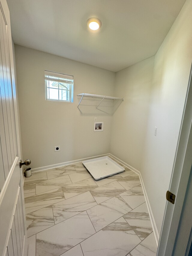 laundry area featuring laundry area, baseboards, hookup for a washing machine, and marble finish floor