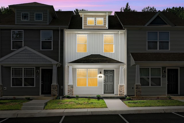 townhome / multi-family property featuring board and batten siding and stone siding