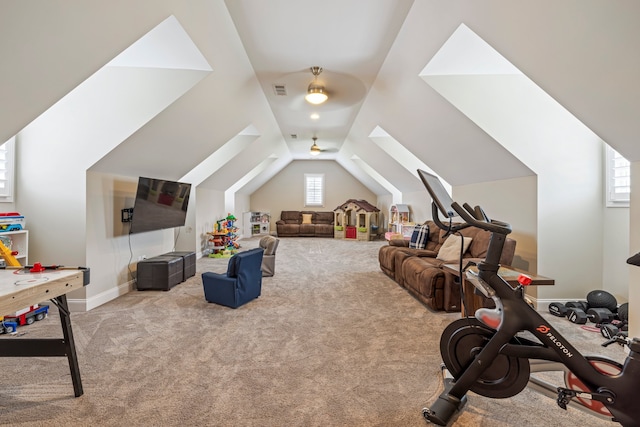 workout room with lofted ceiling, ceiling fan, and light colored carpet