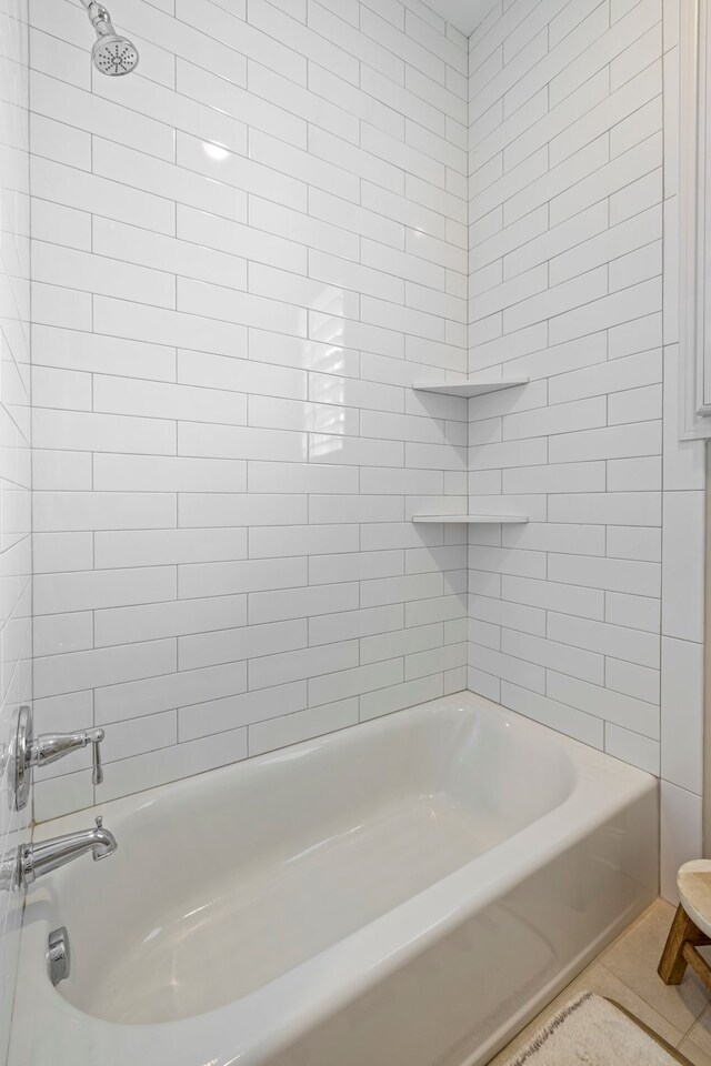 bathroom with tile flooring and tiled shower / bath combo