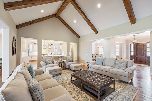 living room with an inviting chandelier, high vaulted ceiling, beam ceiling, and hardwood / wood-style flooring